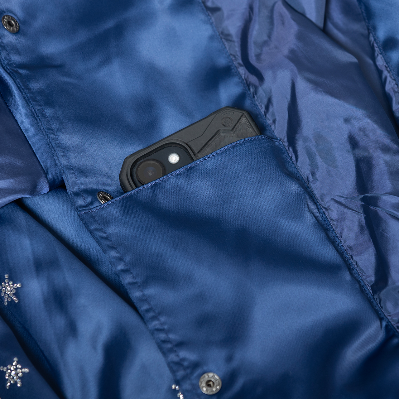 Black phone case in a blue jacket pocket