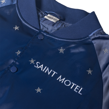 Blue jacket with 'Saint Motel' embroidery and snowflake patterns on a white background